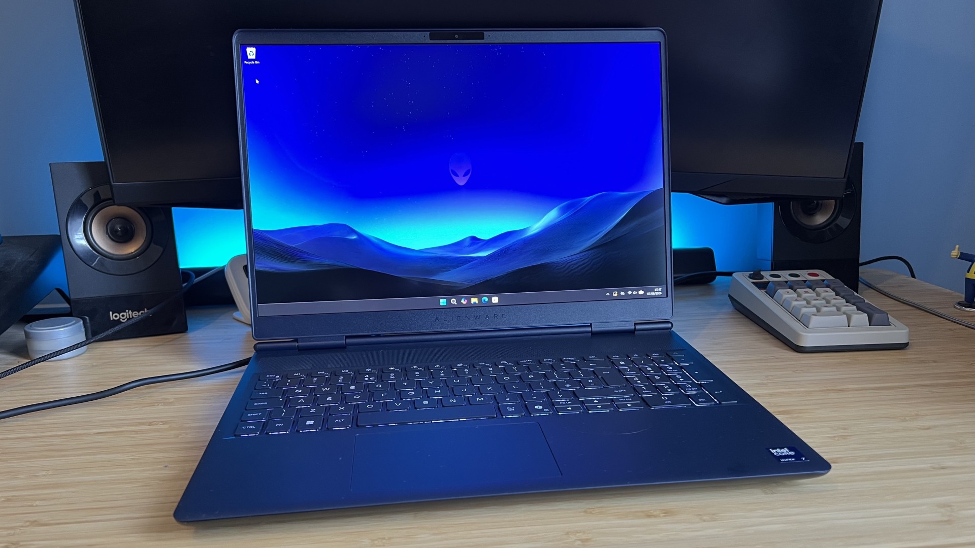Alienware 16X Aurora 2026 gaming laptop showing desktop screen on a wooden desk