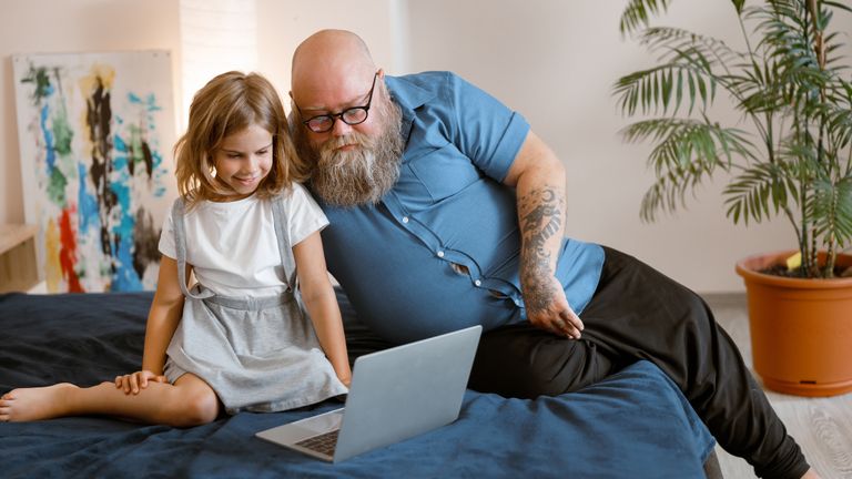 Man helping his daughter with homework