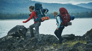 Elizabeth Killham and Robin Moore walking across Alaskan terrain in Race to Survive Alaska
