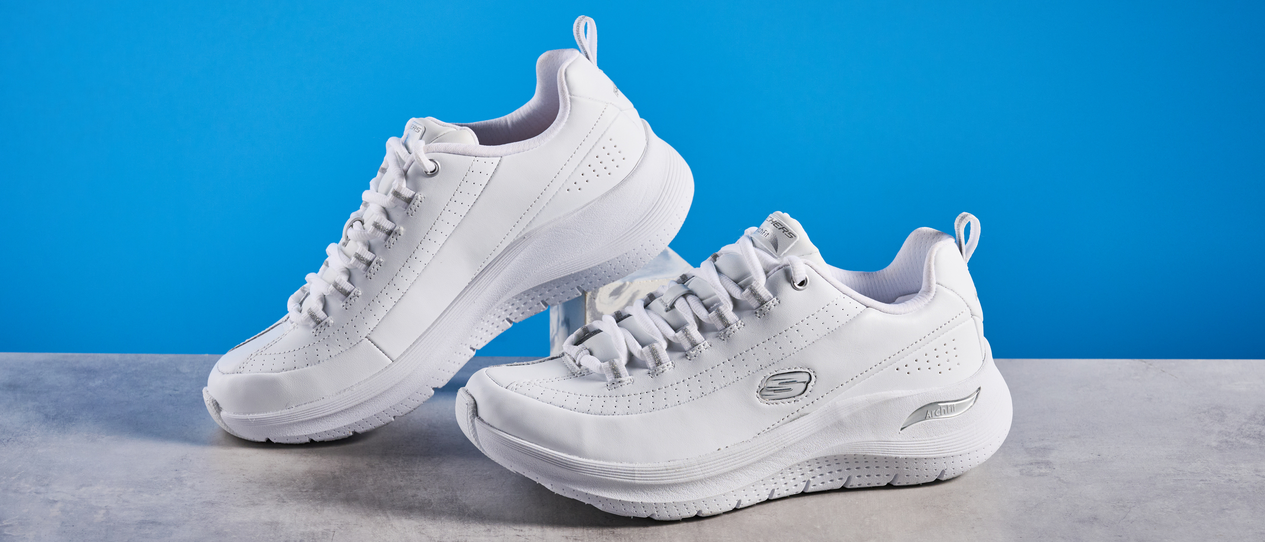 Skechers Arch Fit 2.0 Star Bound photographed in front of a blue background.