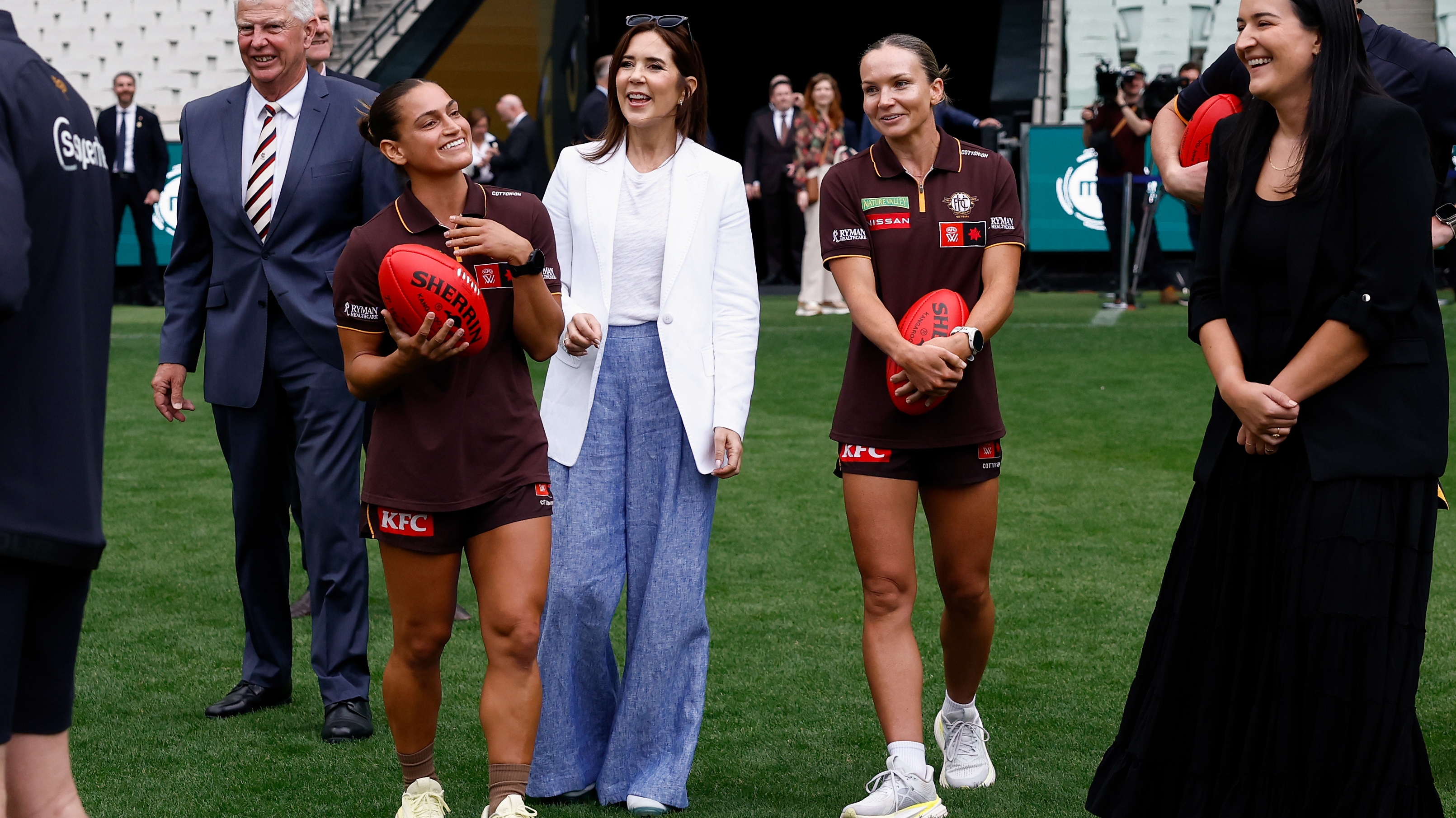 Fred Oldfield (President, Melbourne Cricket Club), Eliza West (Hawthorn Football Club AFLW player), Queen Mary of Denmark, Emily Bates (Hawthorn Football Club AFLW player) and Laura Kane (Executive General Manager Football Operations Australian Football League) are seen during the Danish Royal visit of the MCG at the Melbourne Cricket Ground