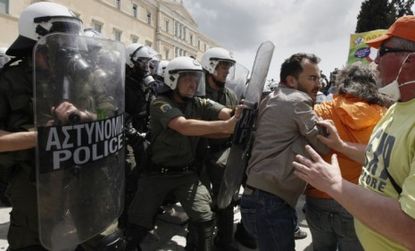 Riot police block municipal workers Wednesday during a march against austerity in Athens