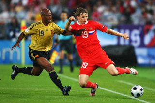 Spain's Marcos Senna (left) challenges Russia's Roman Pavlyuchenko at Euro 2008.