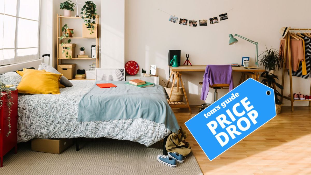 A cosy looking bed sits in the middle of a college dorm room - a Tom&#039;s Guide Price Drop deals badge is laid over the top of the image