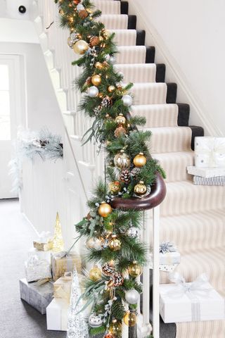bannister decorated with pine cone garland
