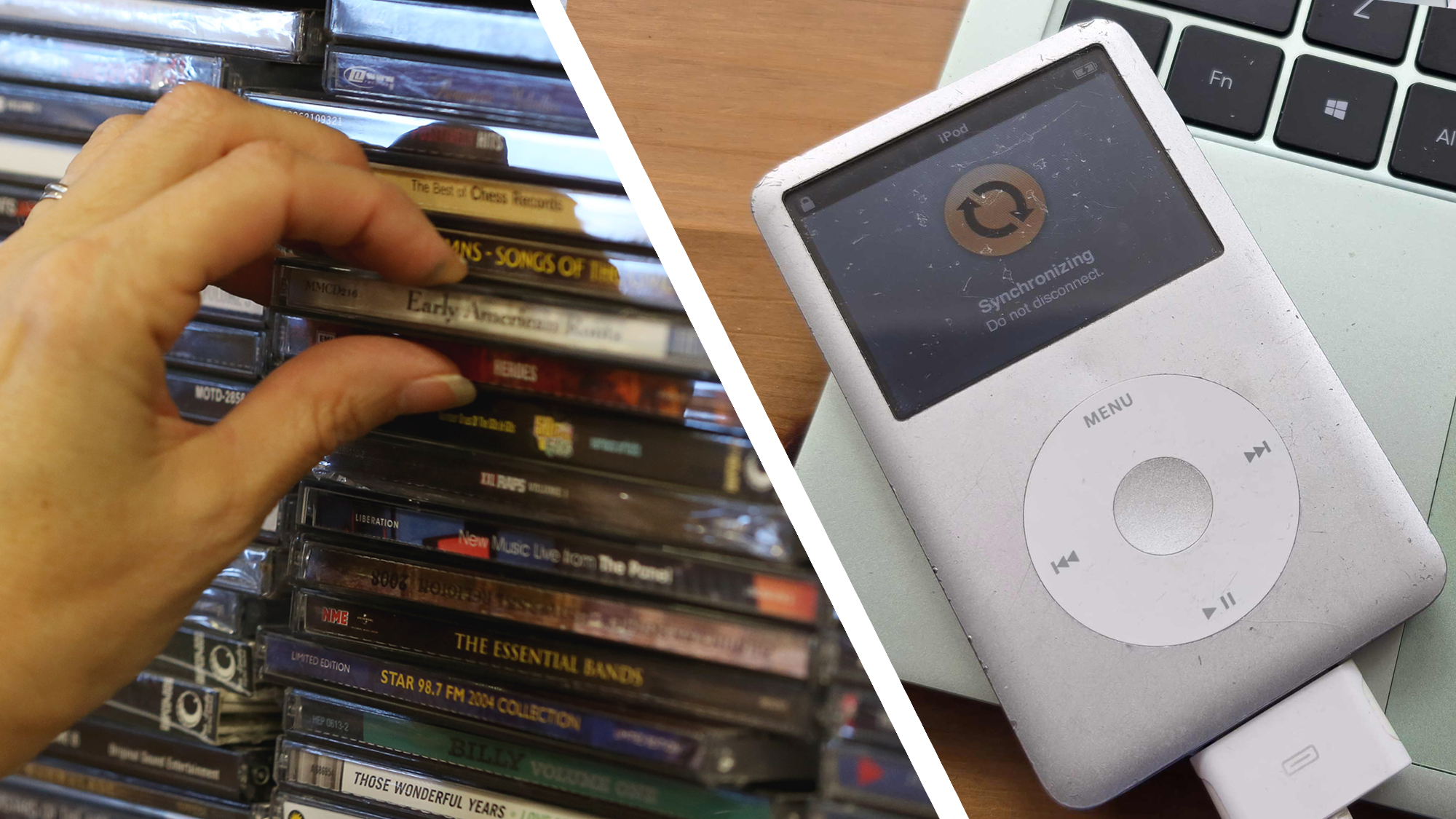 A hand pulling out a CD from a collection next to an iPod resting on a laptop