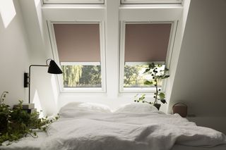 a calm, neutral room with roof windows in a loft bedroom