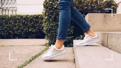 Photo of woman walking down steps with white trainers on and jeans, representing walking 30 minutes a day