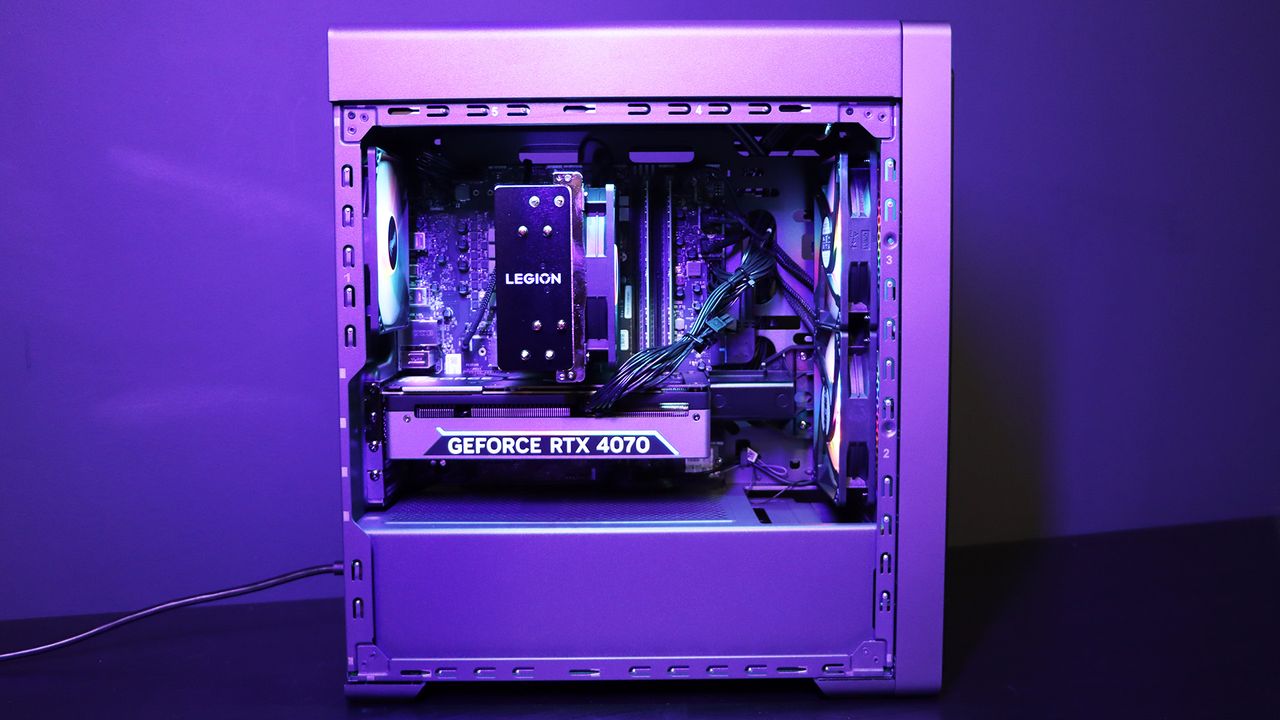 Lenovo Legion Tower 5i PC on a table with a purple light on it
