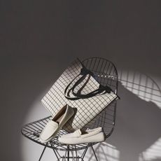 white flat shoes and matching tote bag with black minimalist gridded design by Rothy's