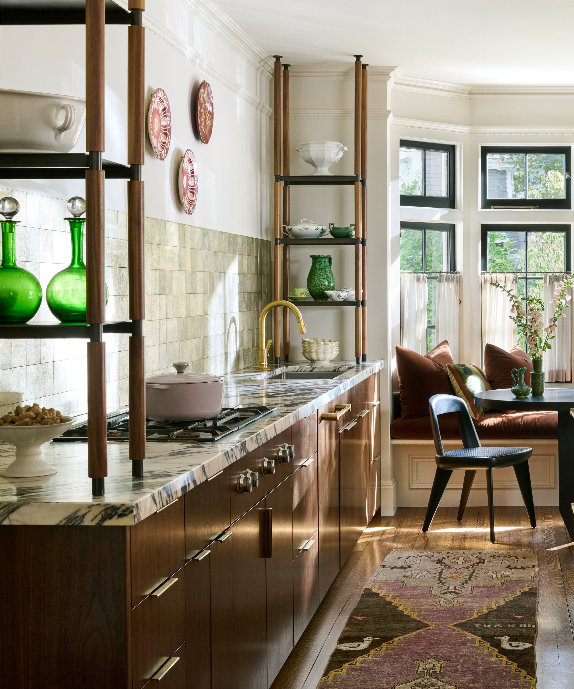 A dark wood kitchen with square countertop shelving to the ceiling