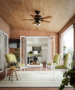 A covered outdoor seating area with a ceiling fan