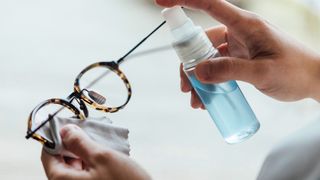 woman cleaning glasses