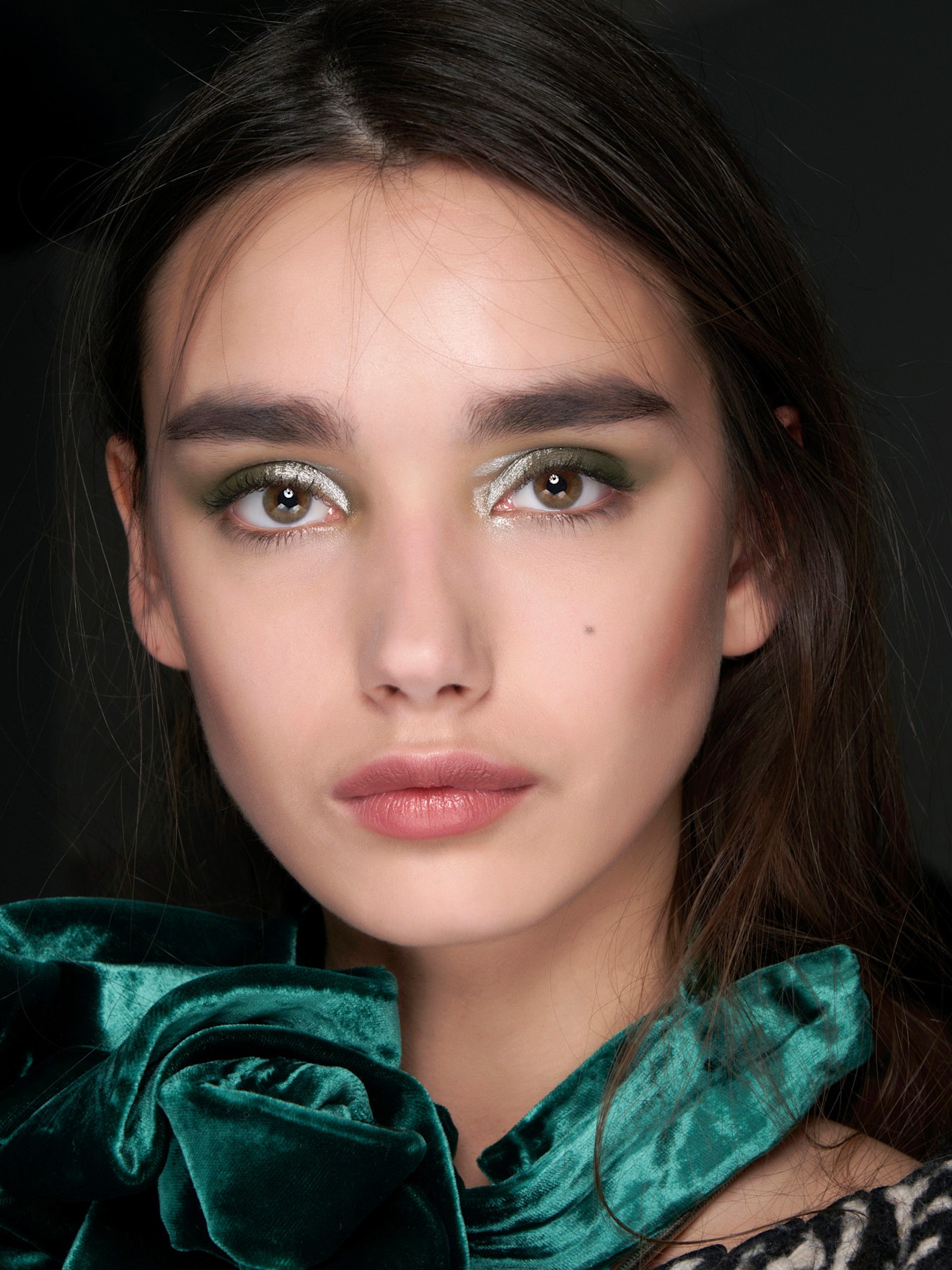 A model wearing a New Years Eve-ready makeup look.