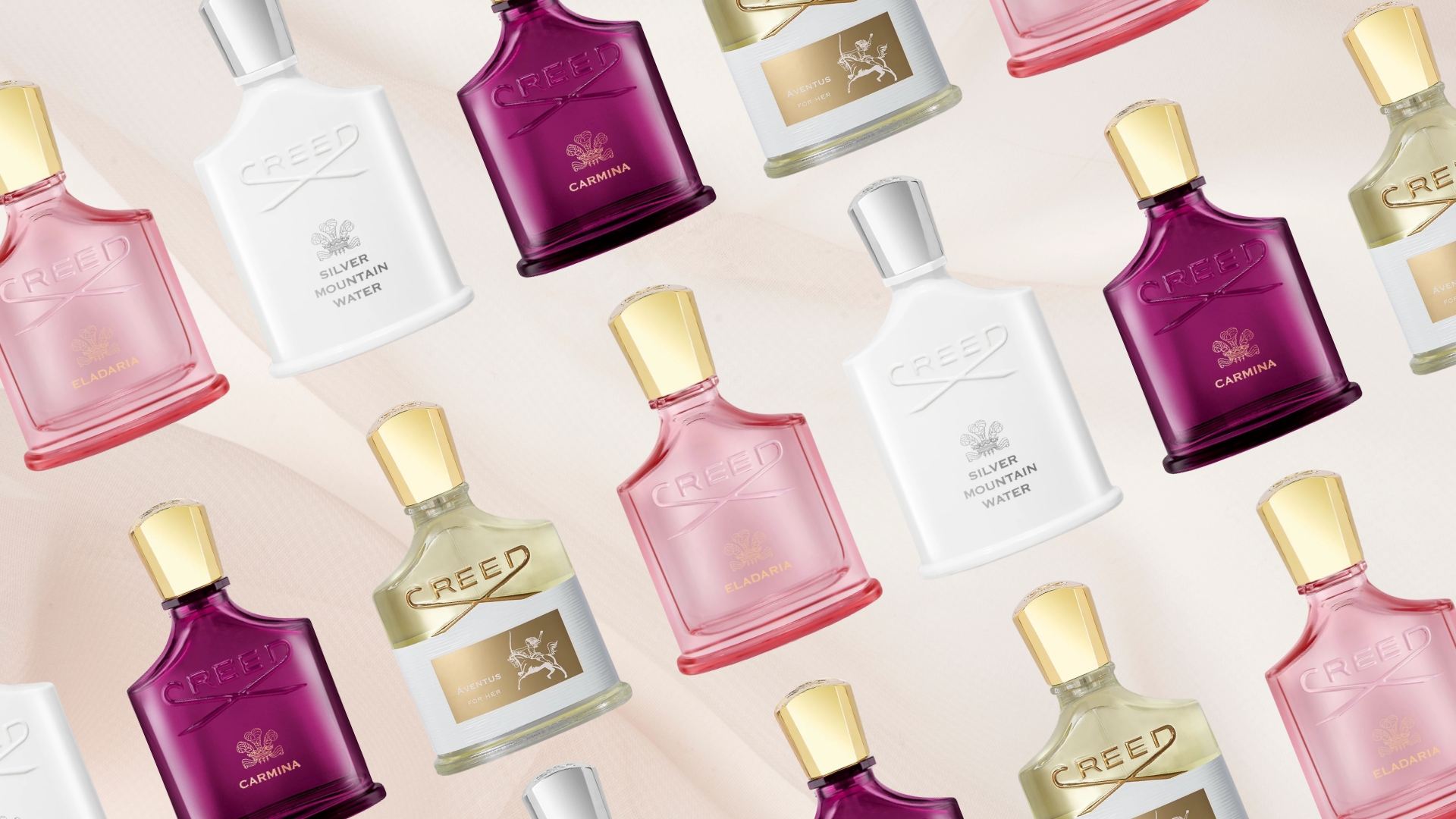 A collage of the best Creed perfumes featured in this guide, including Eladaria, Silver Mountain Water, Carmina and Aventus For Her, all arranged in a diagonal line and repeated across a pastel pink silk fabric-like background
