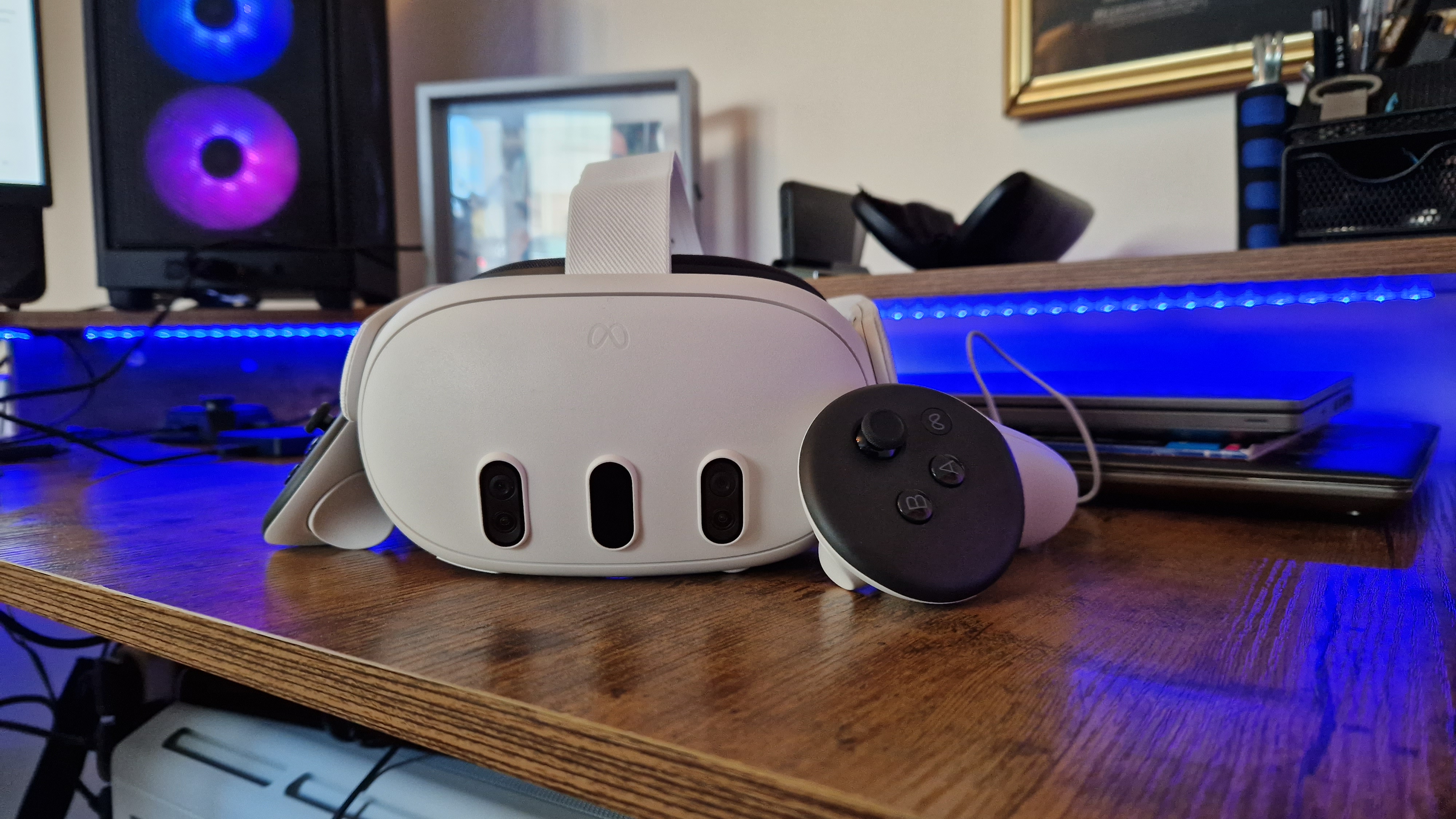 Meta Quest 3 review header image of the headset next to its controllers on a gaming desk