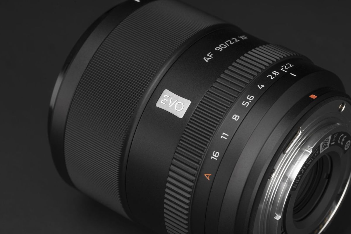 Close up of the Viltrox AF 90mm F2.2 EVO lens on a black background