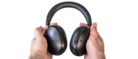 Sonos Ace headphones in black in hand.