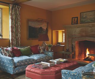 living room with yellow walls and patterned blue sofa