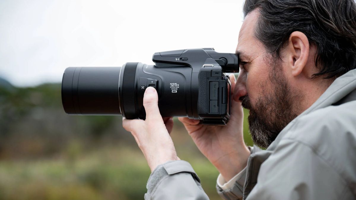 Photographer using a Nikon Coolpix P1100 in an outdoor setting