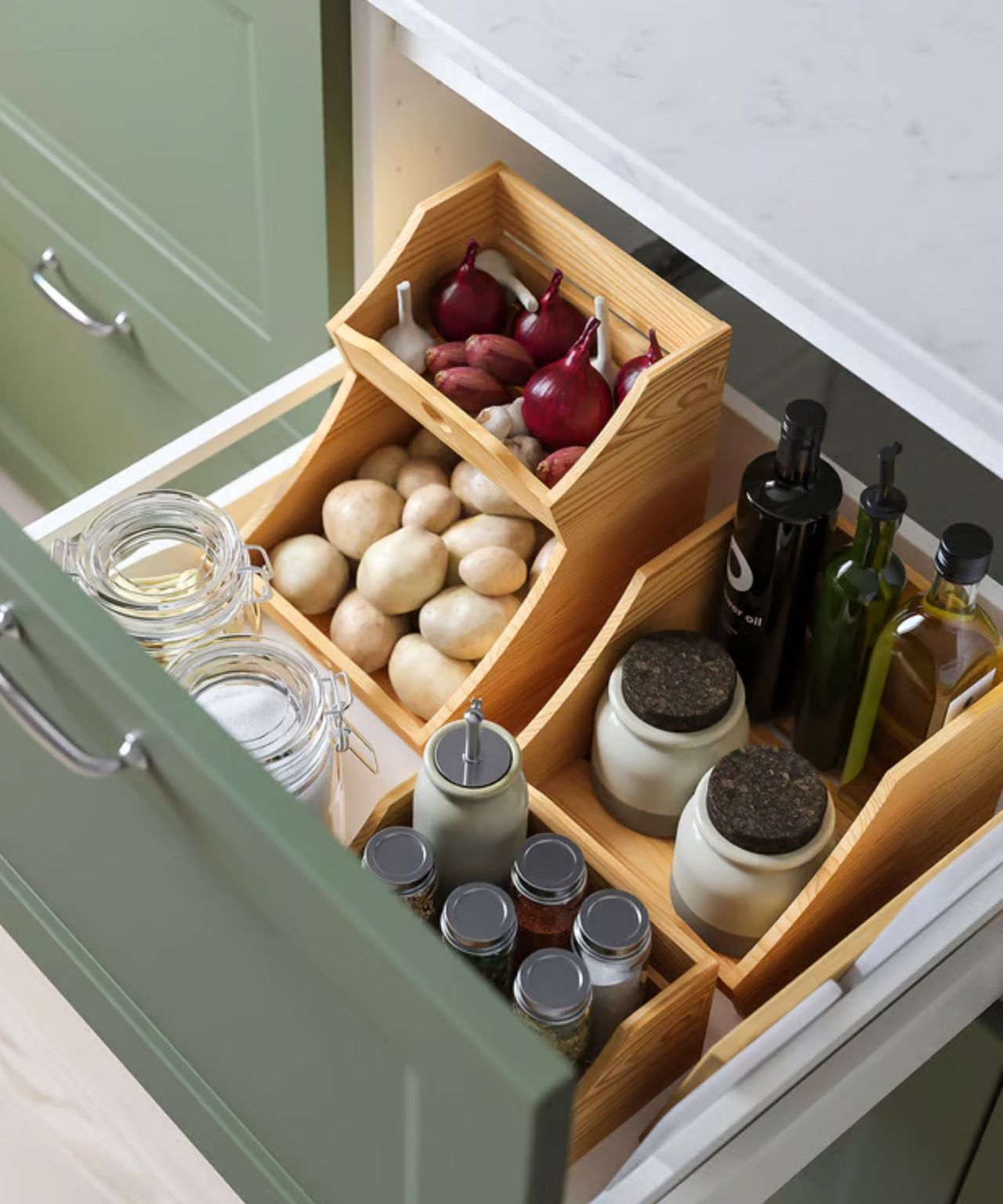 IKEA's stacking food boxes in a kitchen drawer, filled with onions and garlic on top layer, and potatoes on the lower one