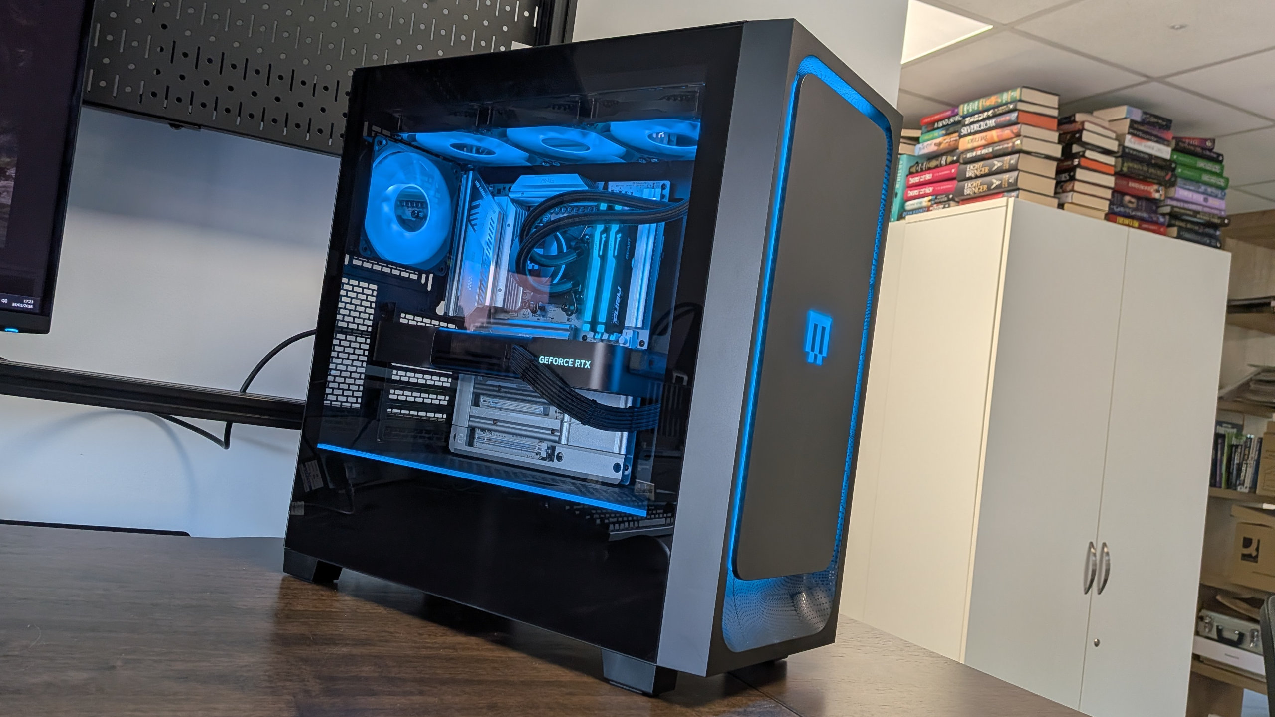 A photo of a Maingear MG-1 Mk.II gaming PC on a desk, with its RGB lighting enabled