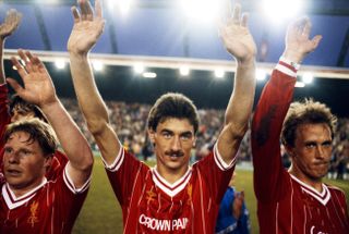 Ian Rush (centre), alongside team-mates Sammy Lee and Phil Neal, waves to the fans after a match for Liverpool against Norwich City in May 1984.