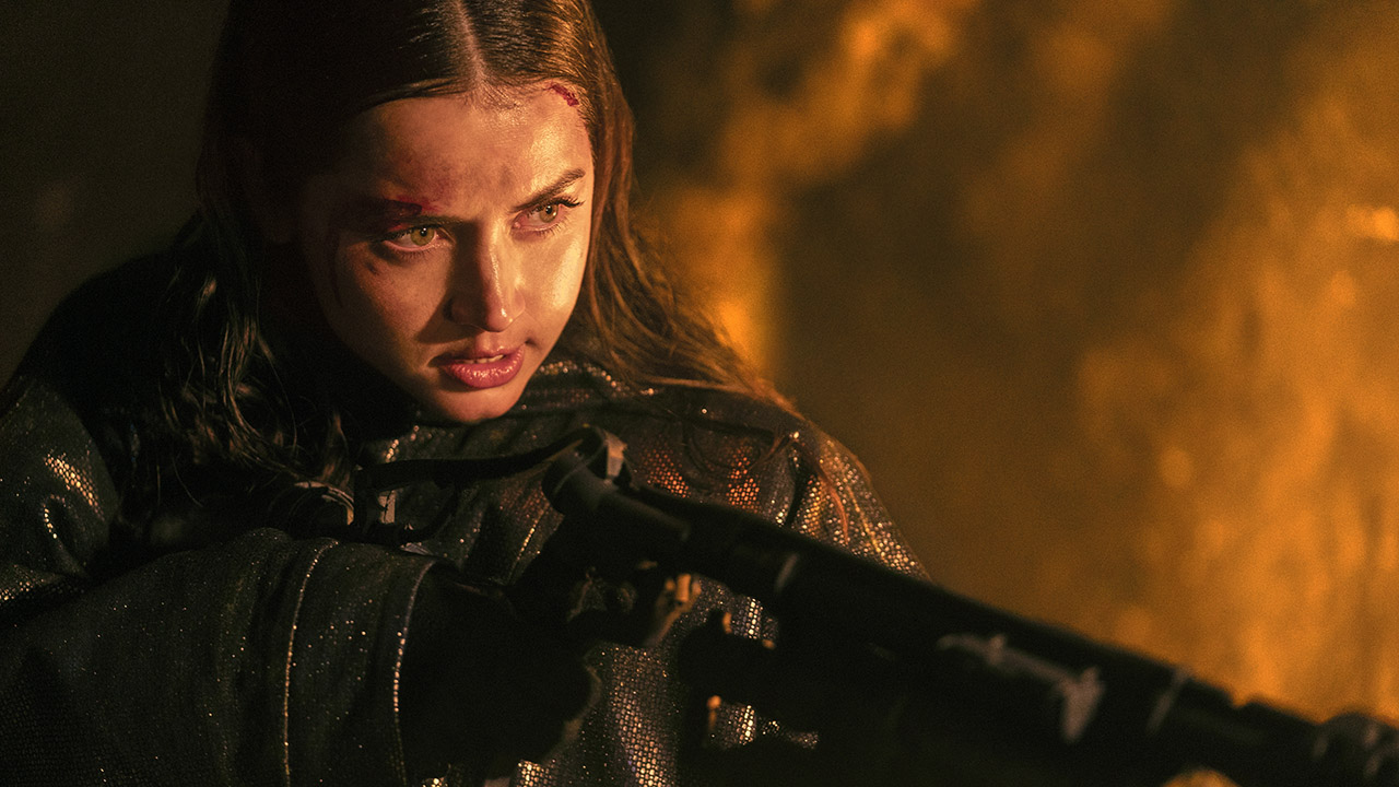 A close up of Ana de Armas&#039; Eve Macarro holding a flamethrower at night in From the World of John Wick: Ballerina
