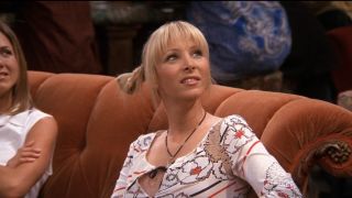 Phoebe looking upward from the couch in Friends