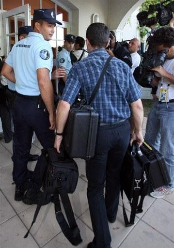 French gendarmes arrive to investigate the Astana team's hotel after it was announced the squad's Alexandre Vinokourov tested positive to blood doping.