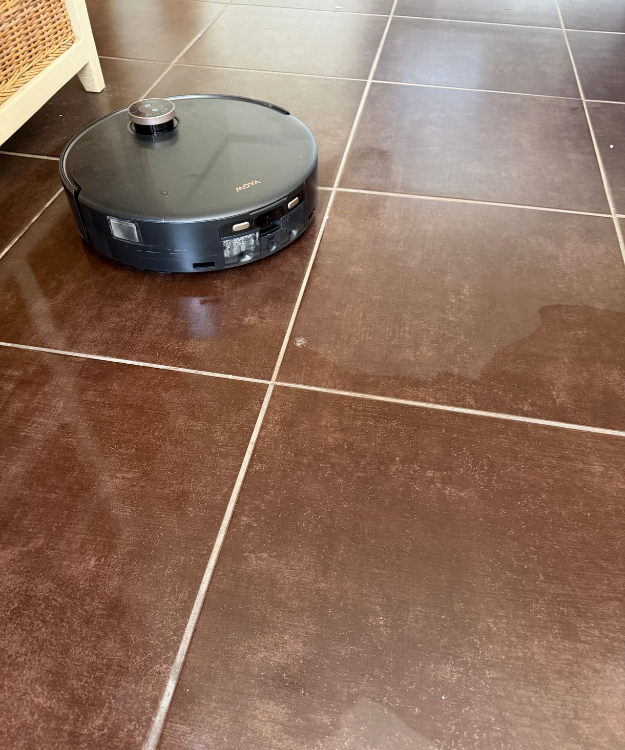 A MOVA vacuum/mop mopping a bathroom floor