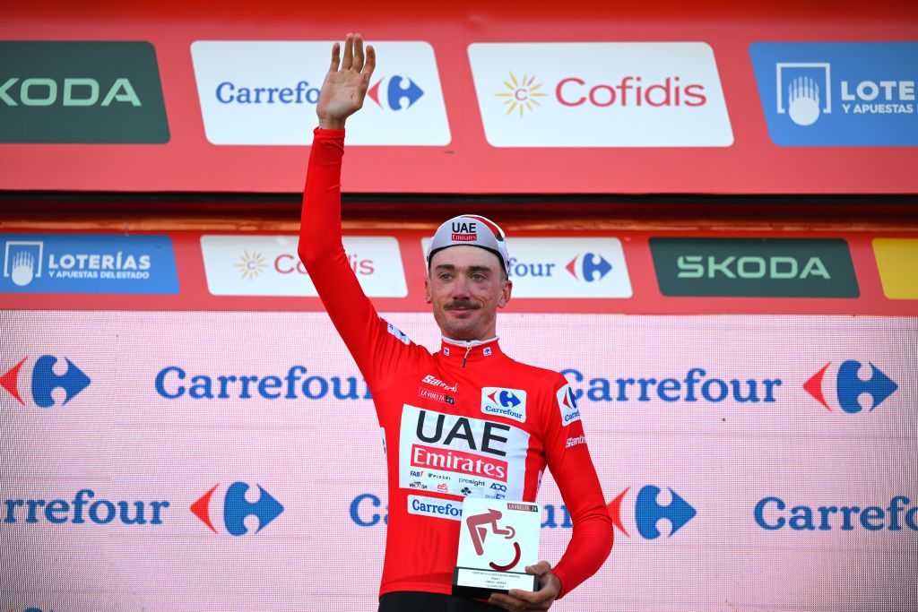 OEIRAS PORTUGAL AUGUST 17 Brandon McNulty of The United State and UAE Team Emirates celebrates at podium as Red Leader Jersey winner during the 79th La Vuelta Ciclista a Espana 2024 Stage 1 a 12km individual time trial stage from Lisbon to Oeiras UCIWT on August 17 2024 in Oeiras Portugal Photo by Tim de WaeleGetty Images