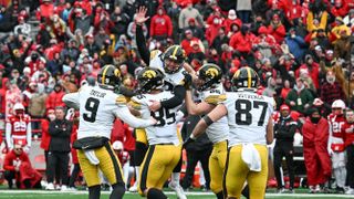 Place kicker Marshall Meeder #92 of the Iowa Hawkeyes is carried by punter Tory Taylor #9 and defensive lineman Logan Lee #85 and tight end Steven Stilianos ahead of the Iowa vs Tennessee Citrus Bowl 2023