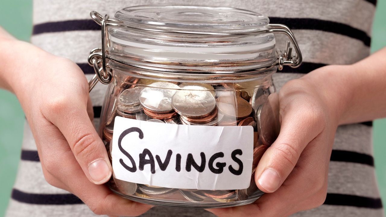 Person holding jar of coins