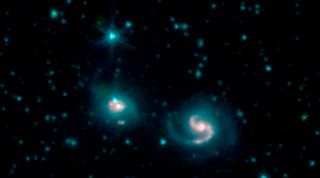 The merging galaxies NGC 6786 (right) and UGC 11415 (left), collectively called VII Zw 96, from images taken by three infrared channels on the Spitzer space telescope.