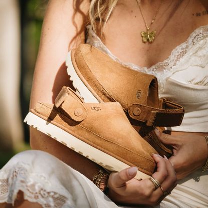 Woman holding UGG footwear