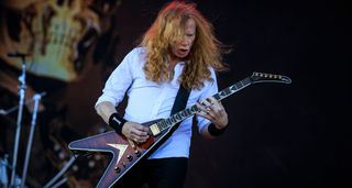Dave Mustaine of Megadeth wears a white shirt and trademark Megadeth sweat bands as he plays his signature Gibson V at Tons of Rock Festival 2025.