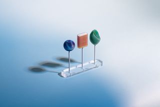 Three material samples on a transparent stand