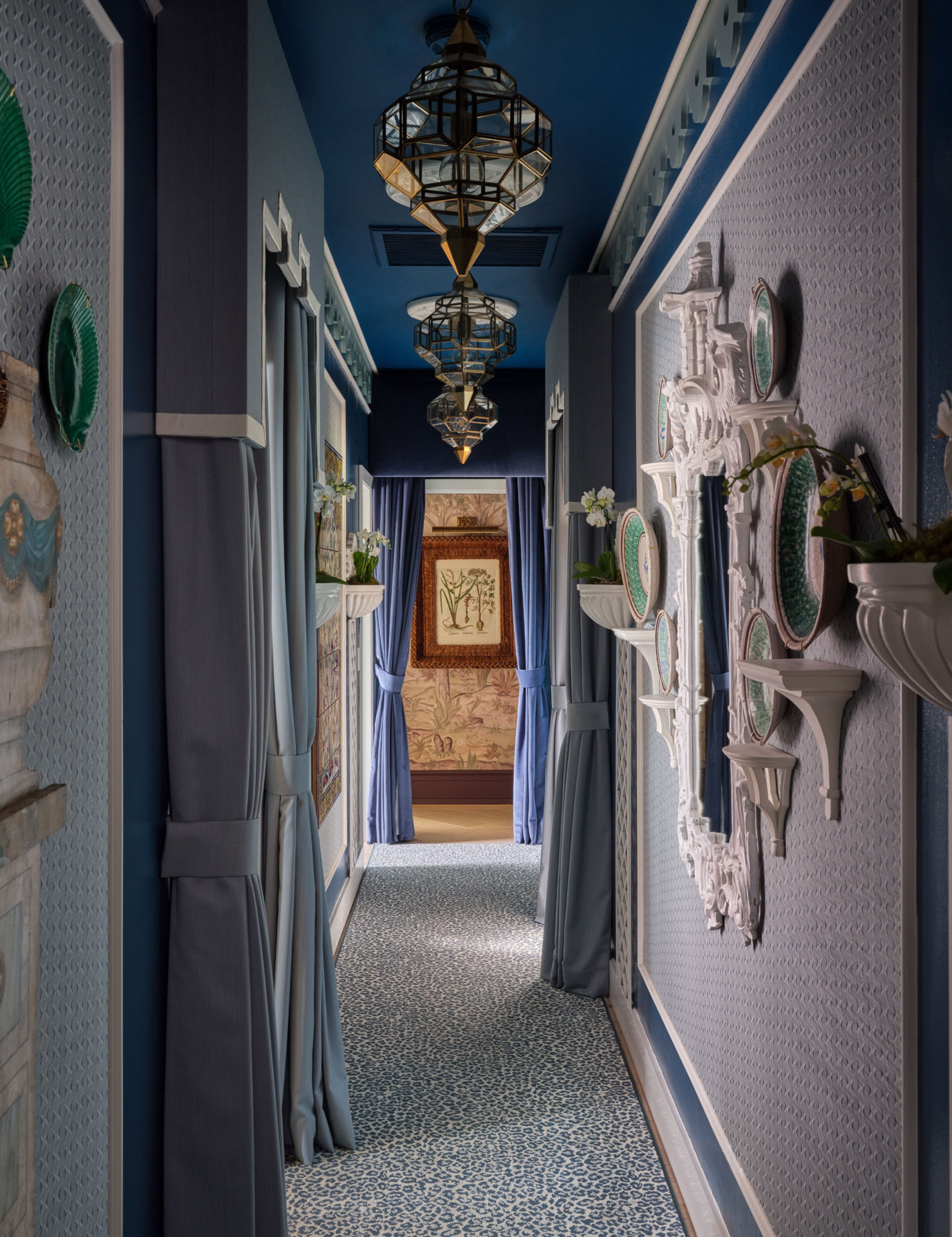 Blue ornately decorated hallway area featuring eclectic artwork and light fixtures