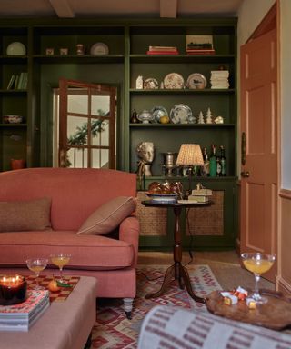 living room with dark green bookshelves decorated for christmas