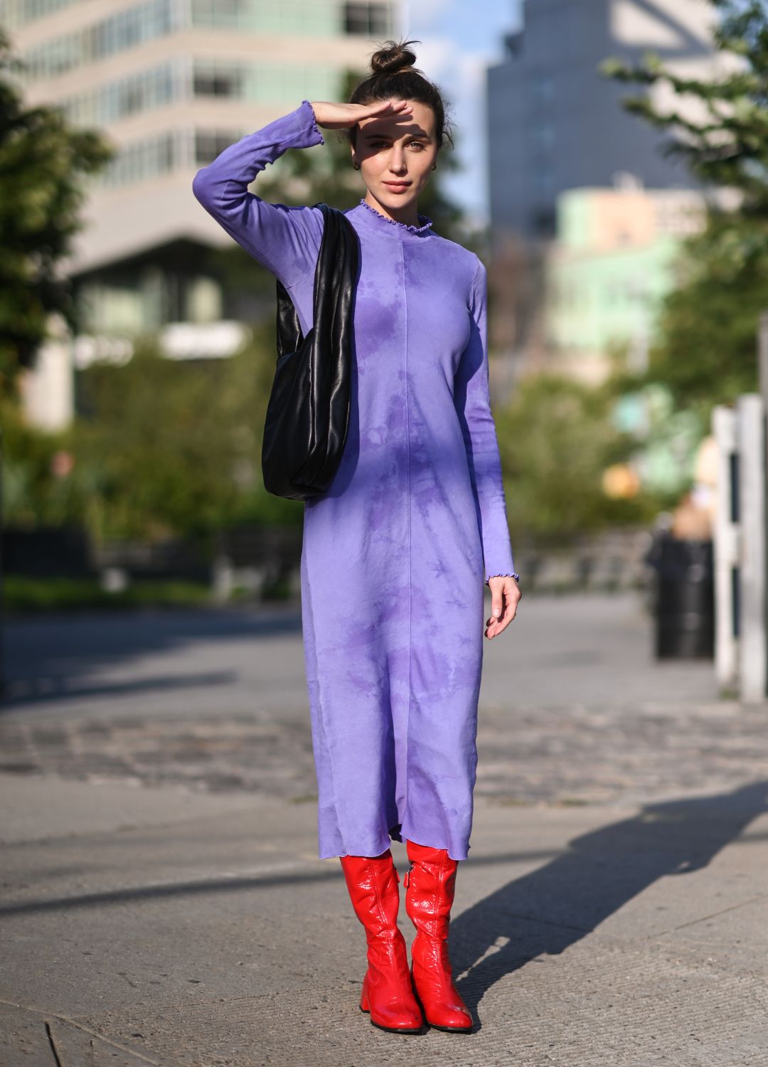 Mary Leest is seen wearing a purple Jonathan Simkhai dress and red boots outside the Jonathan Simkhai show during New York Fashion Week S/S 22 on September 11, 2021 in New York City.
