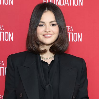 Selena Gomez wearing a bob hairstyle and smiling at the camera.