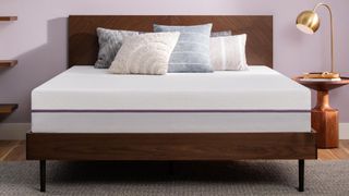 Best mattress for side sleepers: the Purple mattress placed on a wooden bedframe in a light purple bedroom