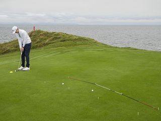 Ben Emerson demonstrating the advanced ladder drill on the green to marry pace and read of putts