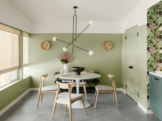 A dining room with a soft green palette