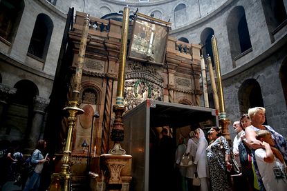 Tourists head to the Tomb of Jesus at the start of renovations.