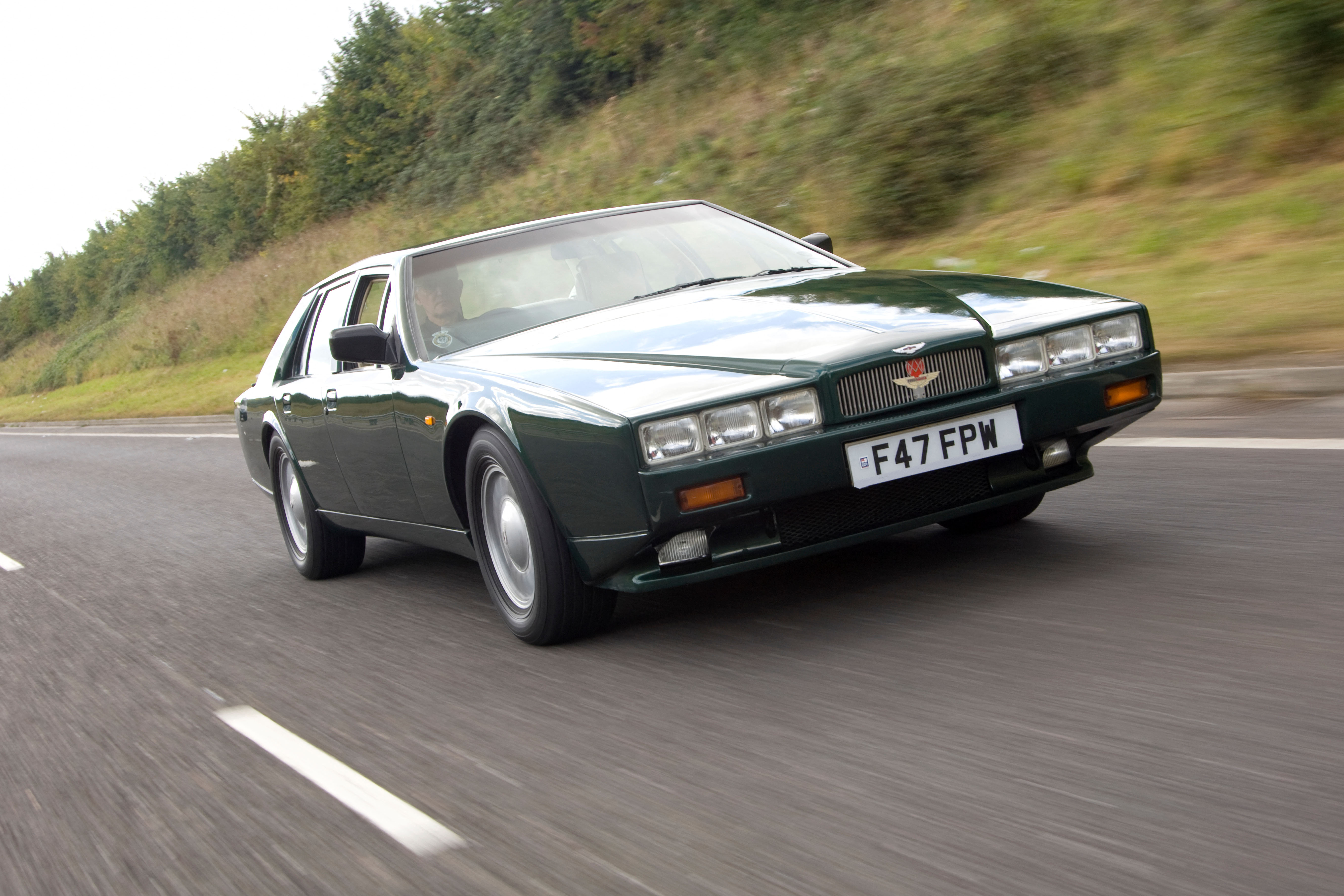 Green Aston Martin Lagonda on the road