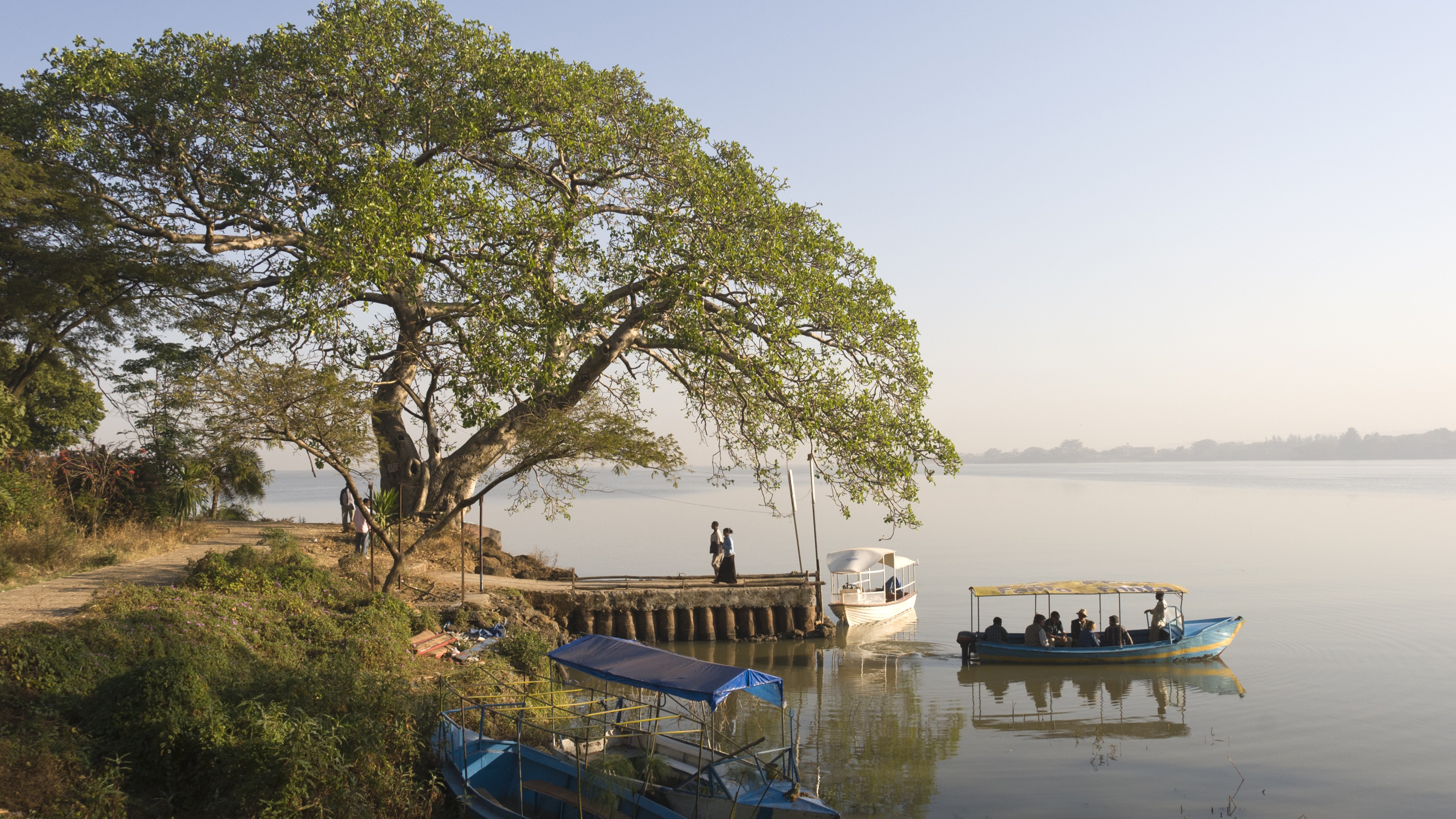 A photo of boats next to an island in Lake Tana