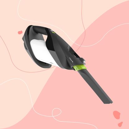 Gtech ProLite Handheld Bagged Vacuum on a pink background