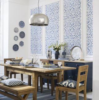 dining room with blue and white wallpaper panels